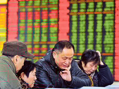 Chinese investors monitor stock prices at a brokerage house in Fuyang in central China’s Anhui province on Friday. The economies of Asia’s largest — China and India — have been continuing to benefit from lower commodity prices. Analysts says the two countries are the most preferred markets.