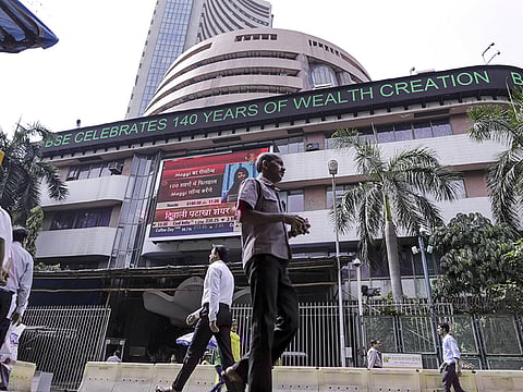 Pedestrians walk past the Bombay Stock Exchange (BSE) in Mumbai, India. The key Indian equity indices declined on Friday  with the BSE Sensex losing close to 900 points.