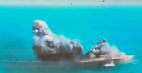This image taken from Iranian state TV, shows damage to a mock US aircraft carrier during large-scale naval and air defence drills by Iran's Revolutionary Guard, near the Strait of Hormuz, Iran,  in a file photo.