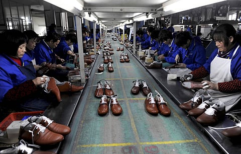 Employees at a shoe factory. Profits at China’s industrial firms grew for the fourth straight month in August, buoyed in part by a rebound in commodities prices and equipment manufacturing.