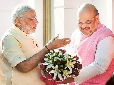 Prime Minister Narendra Modi is greeted by BJP President Amit Shah on his arrival at the party headquarters on the occasion of the first anniversary of his government [2015]