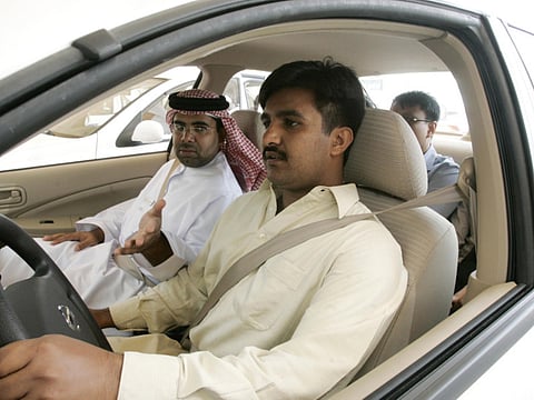 Student taking test and police officers sitting next to the student during the driving class at Emirates driving school in Dubai 