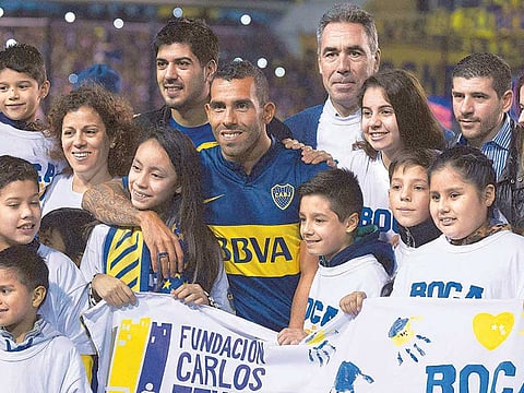 Carlos Tevez (centre), who returned to Boca Juniors, helped his team win the league last month.