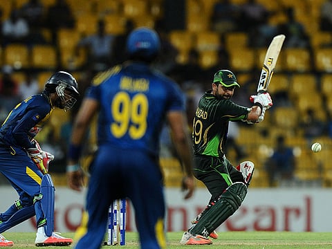 Pakistan cricketer Ahmed Shehzad (right) is watched by Sri Lankan wicketkeeper Dinesh Chandimal (left) back in 2015.