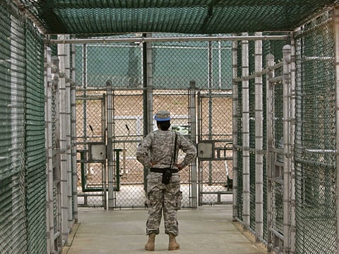 A Guantanamo guard watches over detainees, not pictured, in the exercise area at Camp 5 maximum-security facility at Guantanamo Bay U.S. Naval Base, Cuba (File)