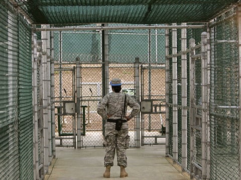 A Guantanamo guard watches over detainees, not pictured, in the exercise area at Camp 5 maximum-security facility at Guantanamo Bay U.S. Naval Base, Cuba (File)