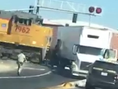 Freight train smashes into stricken lorry
