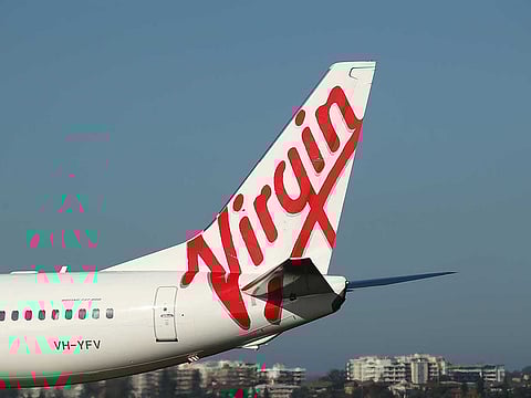 The Virgin Australia Holdings Ltd. logo is displayed on the tail of a Boeing Co. 737-800 aircraft preparing to take off at Sydney Airport in Sydney, Australia, on Monday, Feb. 8, 2016. 