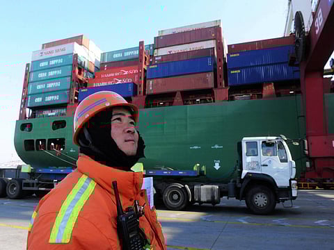 A worker watches over cranes at the port in Qingdao, in China. While the coronavirus outbreak has disrupted global supply chains contractual obligations are facing unprecedented challenges.