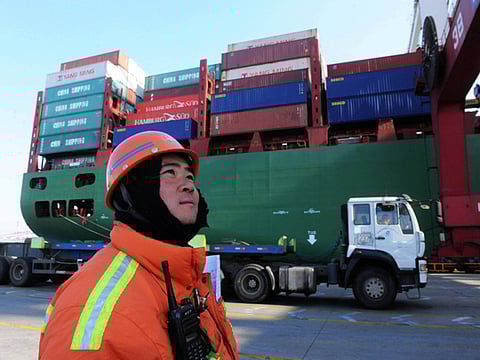 A worker watches over cranes at the port in Qingdao, in China. While the coronavirus outbreak has disrupted global supply chains contractual obligations are facing unprecedented challenges.