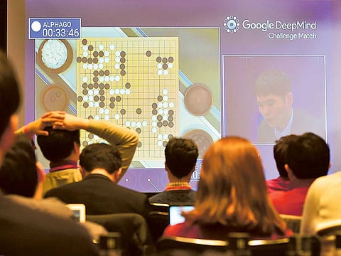 Journalists watch a big screen showing live footage of the third game of the Google DeepMind Challenge Match between Lee Se-Dol and the Google-developed supercomputer AlphaGo