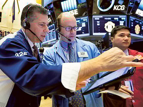 File picture of traders working the charts at the New York Stock Exchange. 