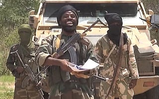 A screengrab taken on July 13, 2014 from a video released by extremist group Boko Haram and obtained by AFP shows the leader of the Nigerian Islamist extremist group Boko Haram, Abubakar Shekau (C). 