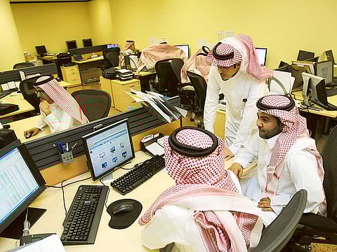 Saudi traders at a brokerage. Saudi Arabia announced a 990 billion riyal budget for 2021 on Tuesday, around 7% less than estimated for this year