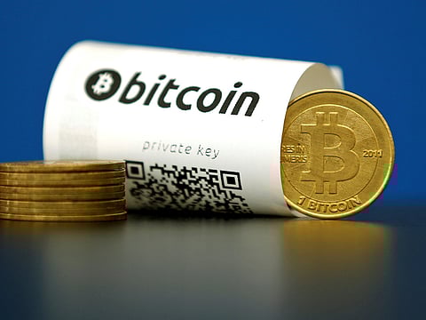 A Bitcoin paper wallet with QR codes and a coin are seen in an illustration picture taken at La Maison du Bitcoin in Paris, France, May 27, 2015. 