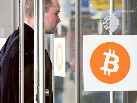 A man enters the Inside Bitcoins conference and trade show in New York. Bitcoin’s code has been updated many times since its founding.