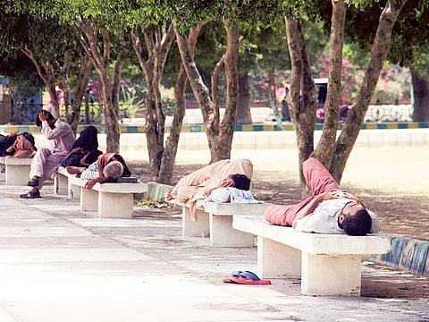 People taking rest under the shade of the trees at Fareer Hall, Karachi.   Prime Minister Imran Khan has launched the Clean Green Pakistan initiative.