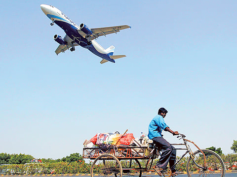 India's civil aviation authority tells airlines to keep the middle seat vacant, but does not say how this should be applied.