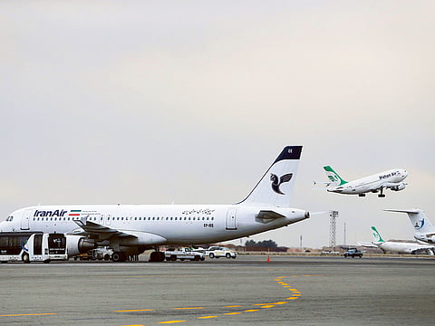 An Iranian Mahan Air passenger plane takes off as a plane of Iran's national air carrier, Iran Air, is parked at left, at Mehrabad airport in Tehran. IRNA said the domestic Mehrabad airport in Tehran and others across the country including Tabriz in the northwest, Mashhad in the northeast and Shiraz in the south are all “operating as scheduled”. 