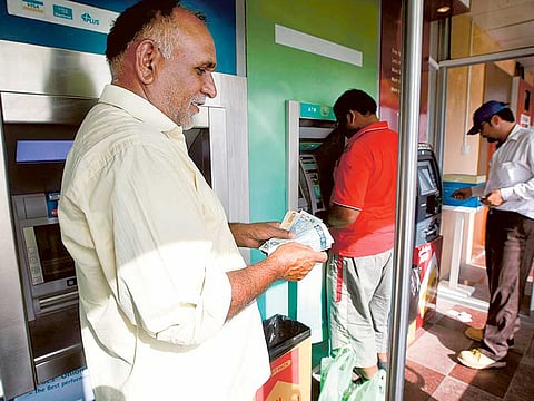 File photo of employees in the UAE obtaining their salaries. Photo for illustrative purpose only. 