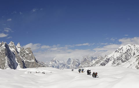 Trekkers hike down the Baltoro glacier in the Karakoram mountain range 
