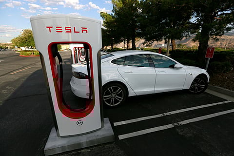 A Tesla Model S charges at a Tesla Supercharger station in Cabazon, California. The company plans to open its network of superchargers to other electric vehicles later this year.