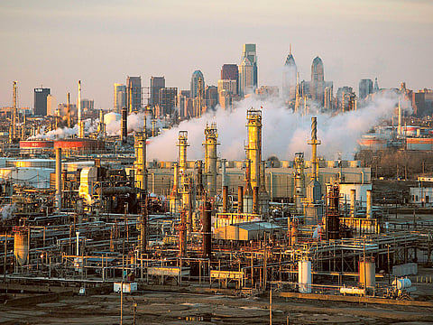 The Philadelphia Energy Solutions oil refinery owned by The Carlyle Group is seen at sunset in front of the Philadelphia skyline. 