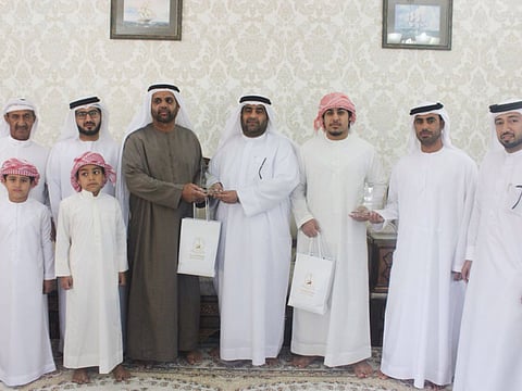 Father, son hailed for saving two teens from drowning