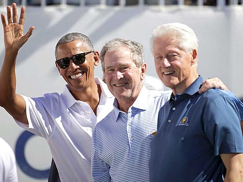 A file photo of former US Presidents Obama, Bush, Clinton as they celebrate the start of Presidents Cup 