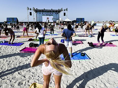 A yoga session in progress at the 2018 Dubai Fitness Challenge weekend carnival at Kite Beach, Dubai