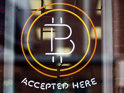 A Bitcoin sign is seen in a window in Toronto, Canada.