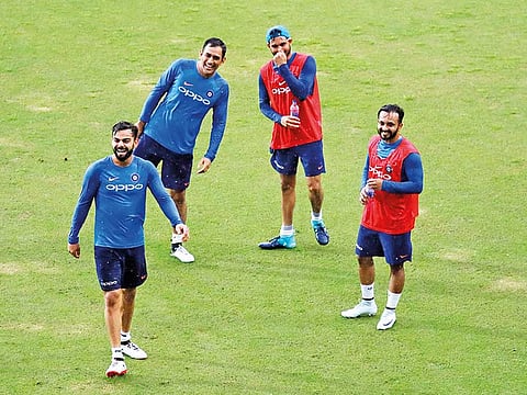 India's Virat Kohli (left) shares a laugh with teammates.