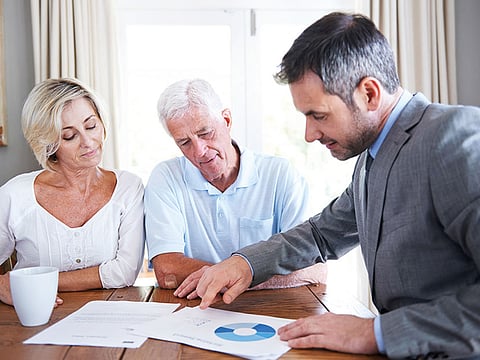 A financial adviser with an elderly couple. Picture used for illustrative purposes. 