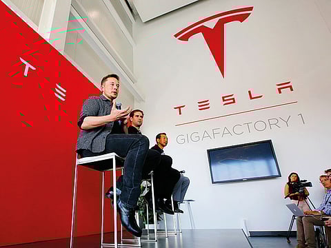 Elon Musk (left), CEO of Tesla, discusses the company’s new Gigafactory in Sparks, Nevada. Musk said in a tweet a ransomware scheme took aim at the electric car company's 1.9 million-square-foot factory in Sparks, which makes batteries for Tesla vehicles and energy storage units.