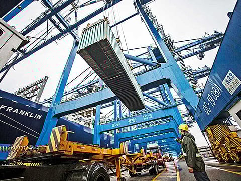 Easy access across borders will not be getting any easier in the coming years. File picture of a dock worker at the Guangzhou Nansha Container Port in China. Image for illustrative purposes.