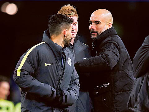 Manchester City manager Pep Guardiola with Kevin De Bruyne and Sergio Aguero