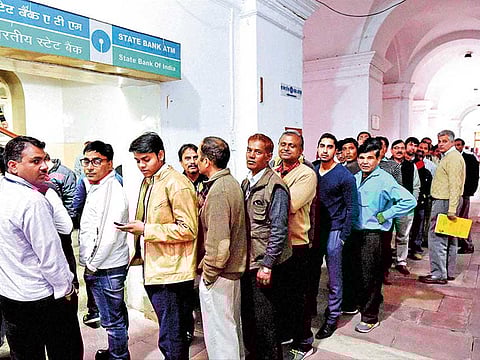 A queue to withdraw cash in front of an State Bank of India ATM. Starting January 1, 2022 a host of charges on banking services in India will go up ranging from cash withdrawals, deposits ATM usage and credit card debt processing charges.