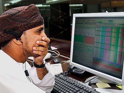 A Omani investor follows share values at the stock exchange in Muscat. Oman’s 30-company index rebounded 0.8 per cent in the morning trade.