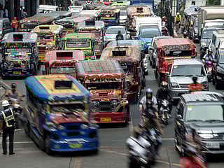 Jeepneys are seen as a traffic enforcer manages a busy street in Manila. Dubbed 'jeepneys' and once hailed as the 'King of the Road' they are a cultural symbol in the Philippines to rival New York's yellow taxis - and for decades they provided cheap and regular transport for millions. The spike in diesel prices due to the Middle East conflict has seen jeepney fees rise.