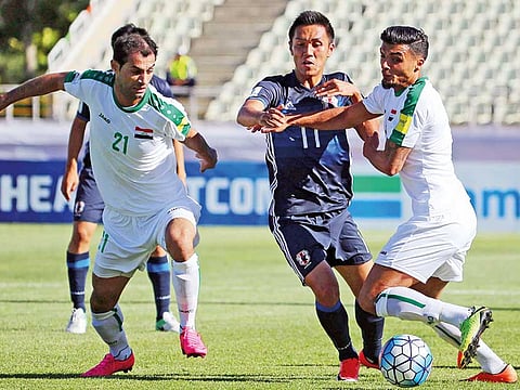 Action between Iraq (in white) and Japanese attacker during their World Cup qualifying match. 