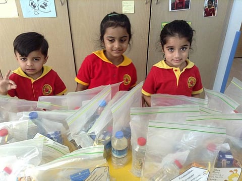 Children make gift boxes for labourers