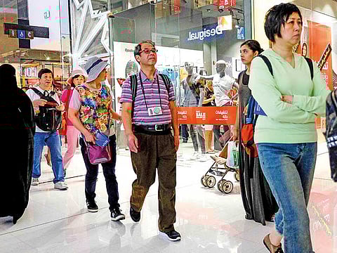 File picture of Chinese tourists file through one of Dubai's leading malls. There has been a spate of cancellation of travel plans in recent days.