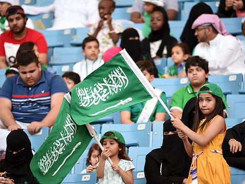 File picture: A Saudi girl waves the national flag in a stadium in the capital Riyadh.