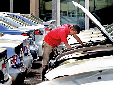A man checks the engine of a car at a used car market. You have the option of buying a car from a used car dealership, or private individuals. In my experience, it pays to buy cars from private sellers rather than dealers, especially when the cars are relatively new (less than 5 years old). Picture for illustrative purpose only.