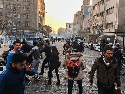A wave of spontaneous protests over a spike in gas prices swept into Tehran with college students and others chanting against the government just hours after hard-liners held their own rally in support of the Islamic Republic's clerical establishment.