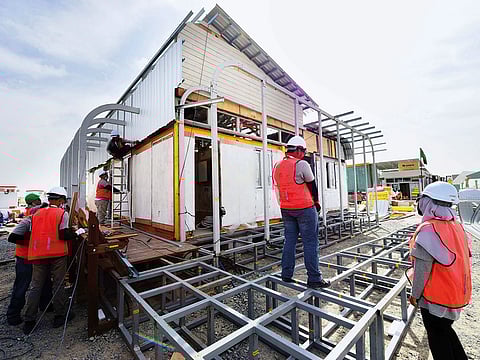 Malaysian students and professors working on their Mizan Home at Mohammad Bin Rashid Solar Park in Al Qudra.