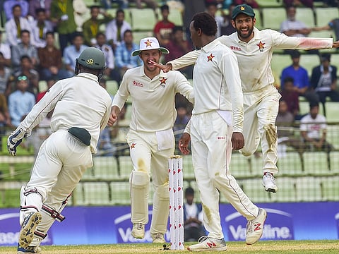 Zimbabwe cricketers celebrate after winning the match on the fourth day of the first Test cricket match between Bangladesh and Zimbabwe in Sylhet on November 6, 2018.