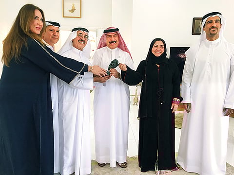 Shaikh Hasher Al Maktoum presents the ITF Award to Abdul Rahman Falaknaz while Nasser Al Marzouqi, Sara Baker, Ahmad Abdul Malek and Roberta Al Julfar look on.