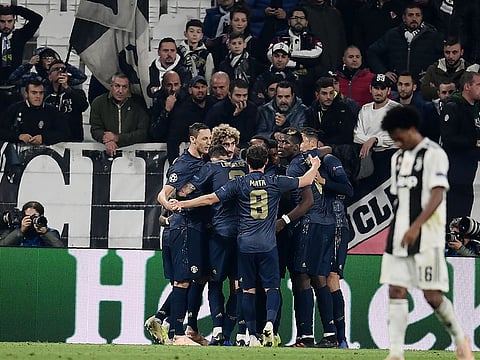 Manchester United celebrate after their second goal against Juventus.