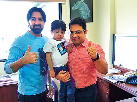 Mohammad with his father, Mohammad Adel Kiani, and doctor Dr Vivek Vij (right).